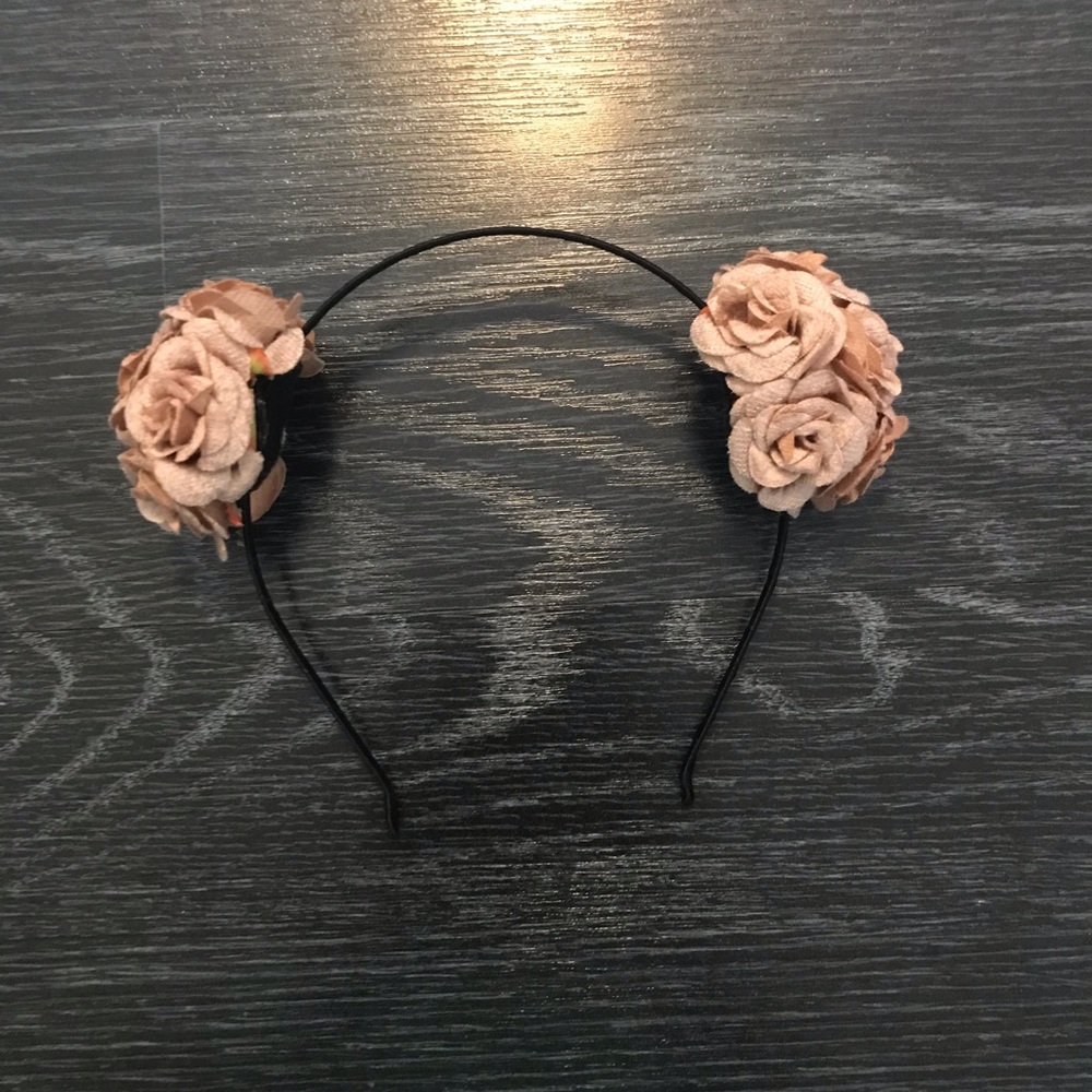 A pretty pink headband with flower “ears”